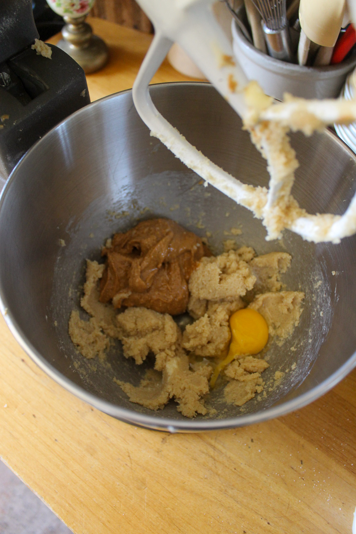 A mixer bowl with peanut butter and egg added to creamed butter and sugar.