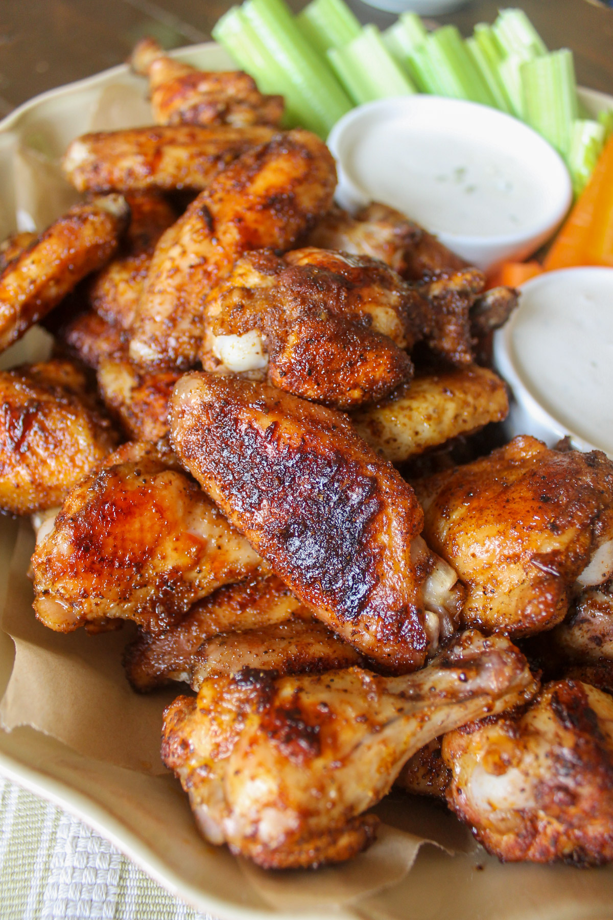 Dry rub baked chicken wings on a platter.