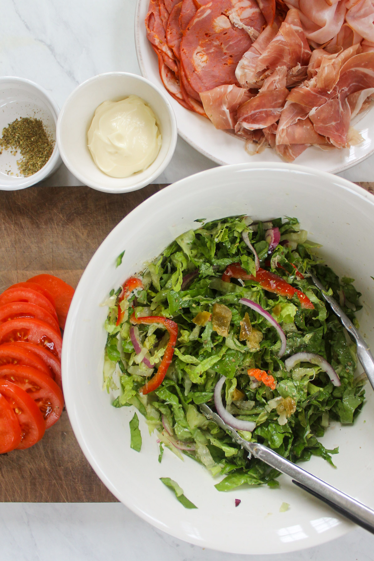 Sliced lettuce peppers and onions tossed with olive oil, red wine vinegar, Parmesan cheese, and dried oregano.