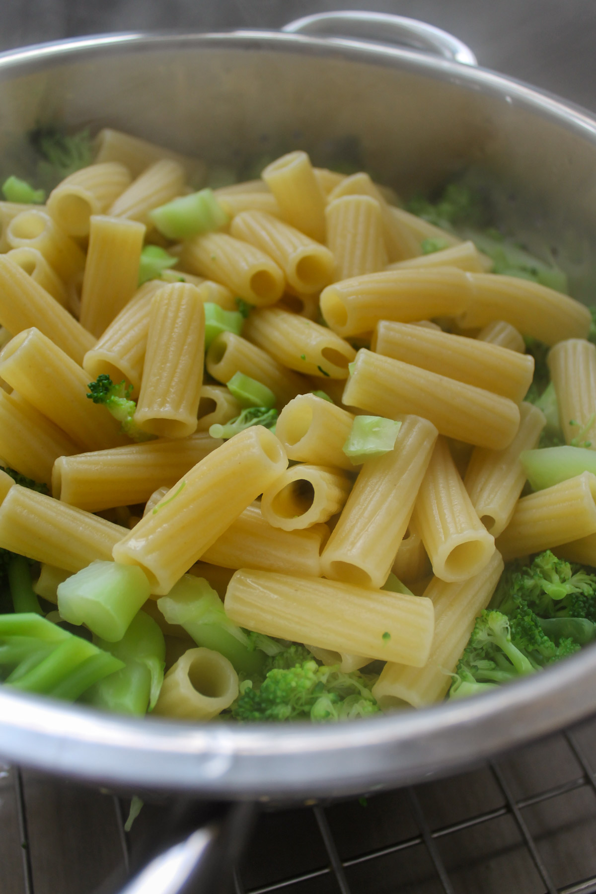 Drained pasta and broccoli in a colander.