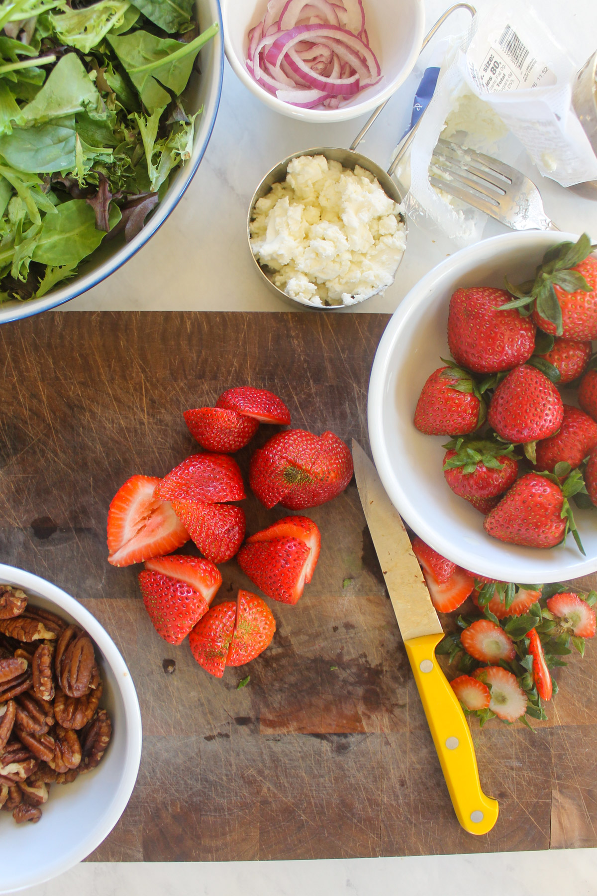Slicing strawberries on a cutting about.