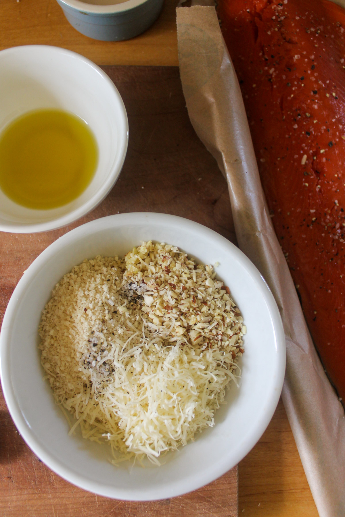 A bowl of almond, panko, and Parmesan cheese topping for salmon.