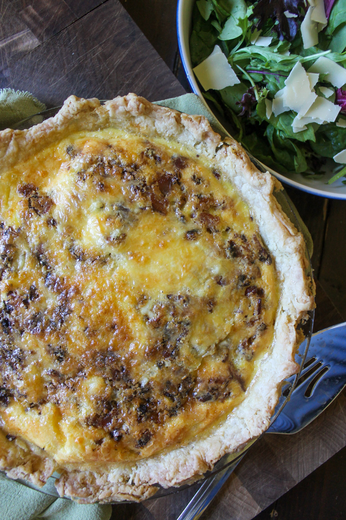 A baked Bacon Onion Quiche with a salad.