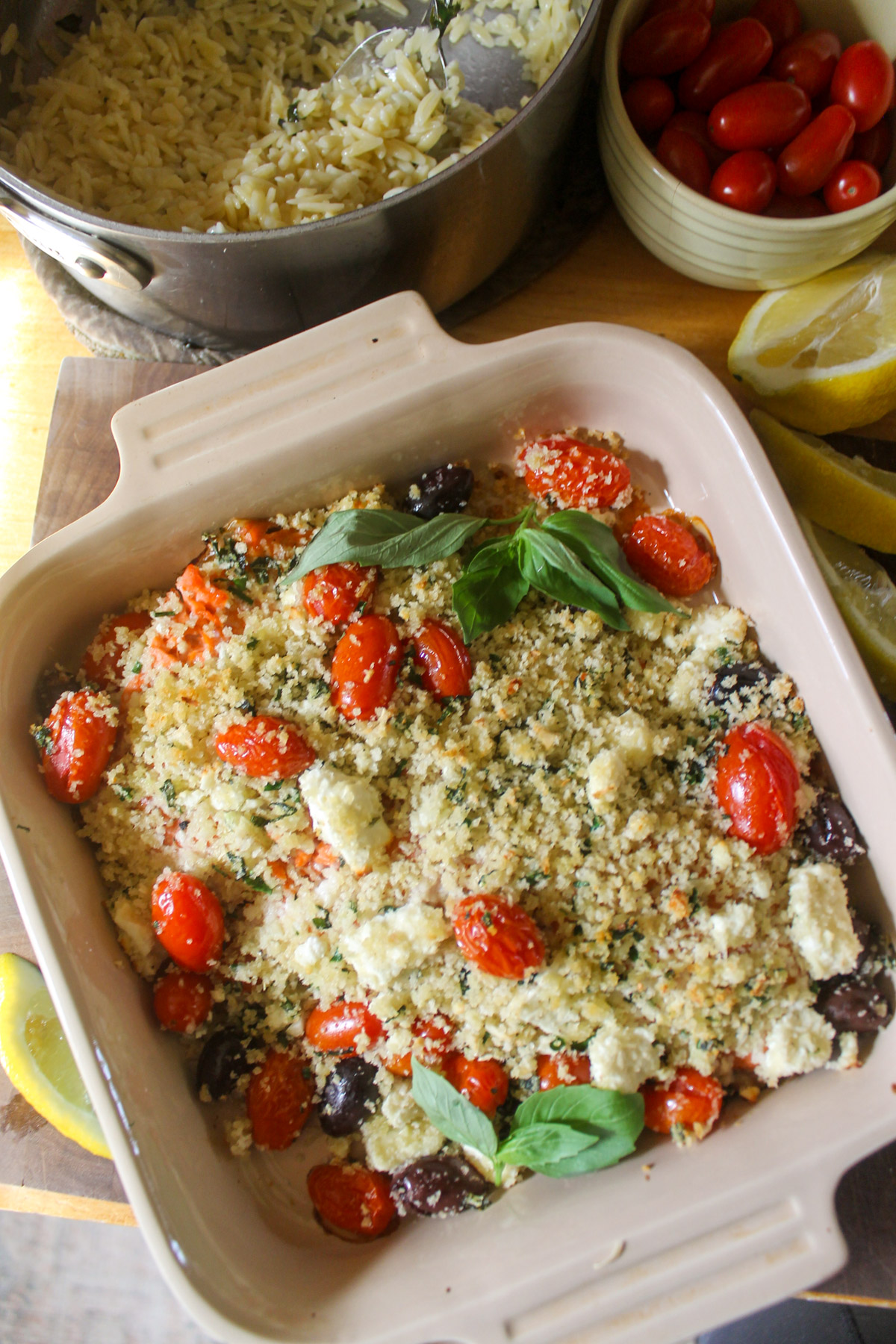 Mediterranean baked salmon topped with panko bread crumbs, cherry tomatoes and a pot of orzo pasta.
