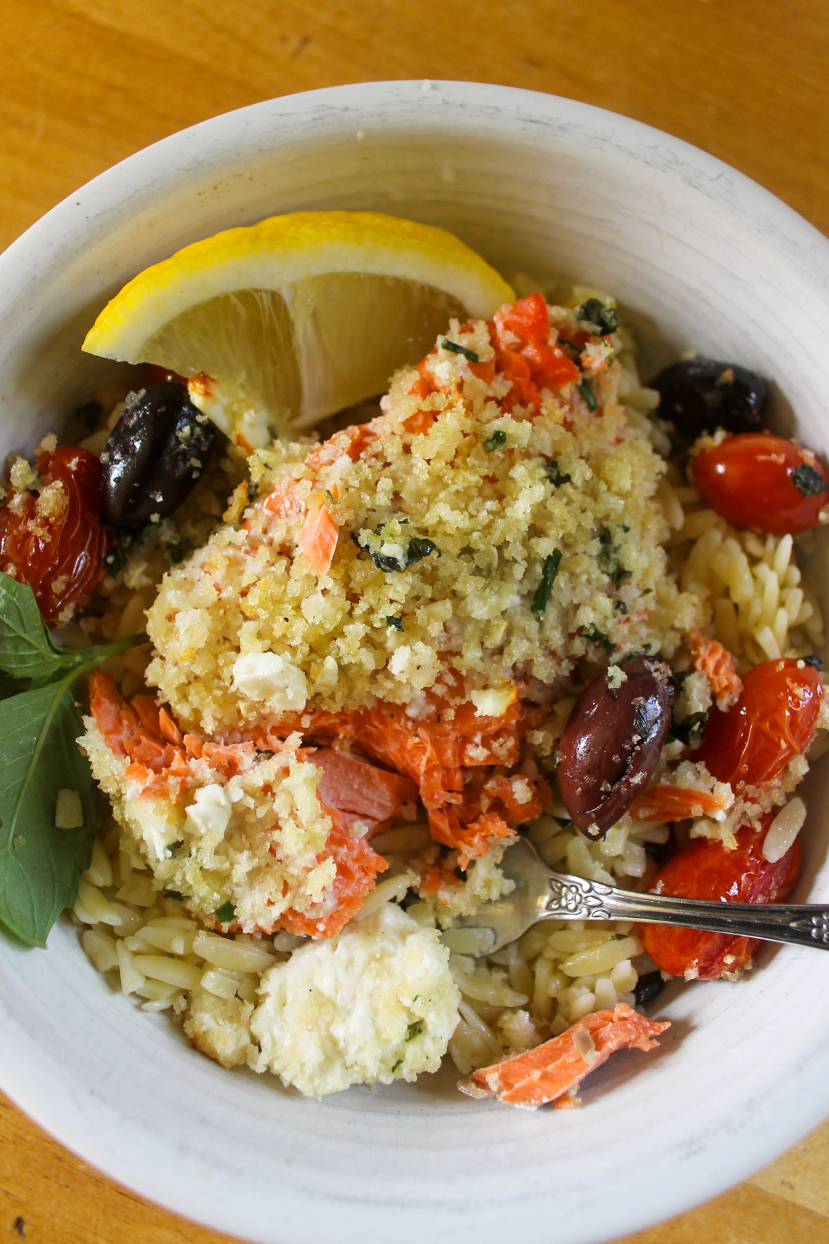 A bowl of Mediterranean Baked Salmon with Lemon Orzo.