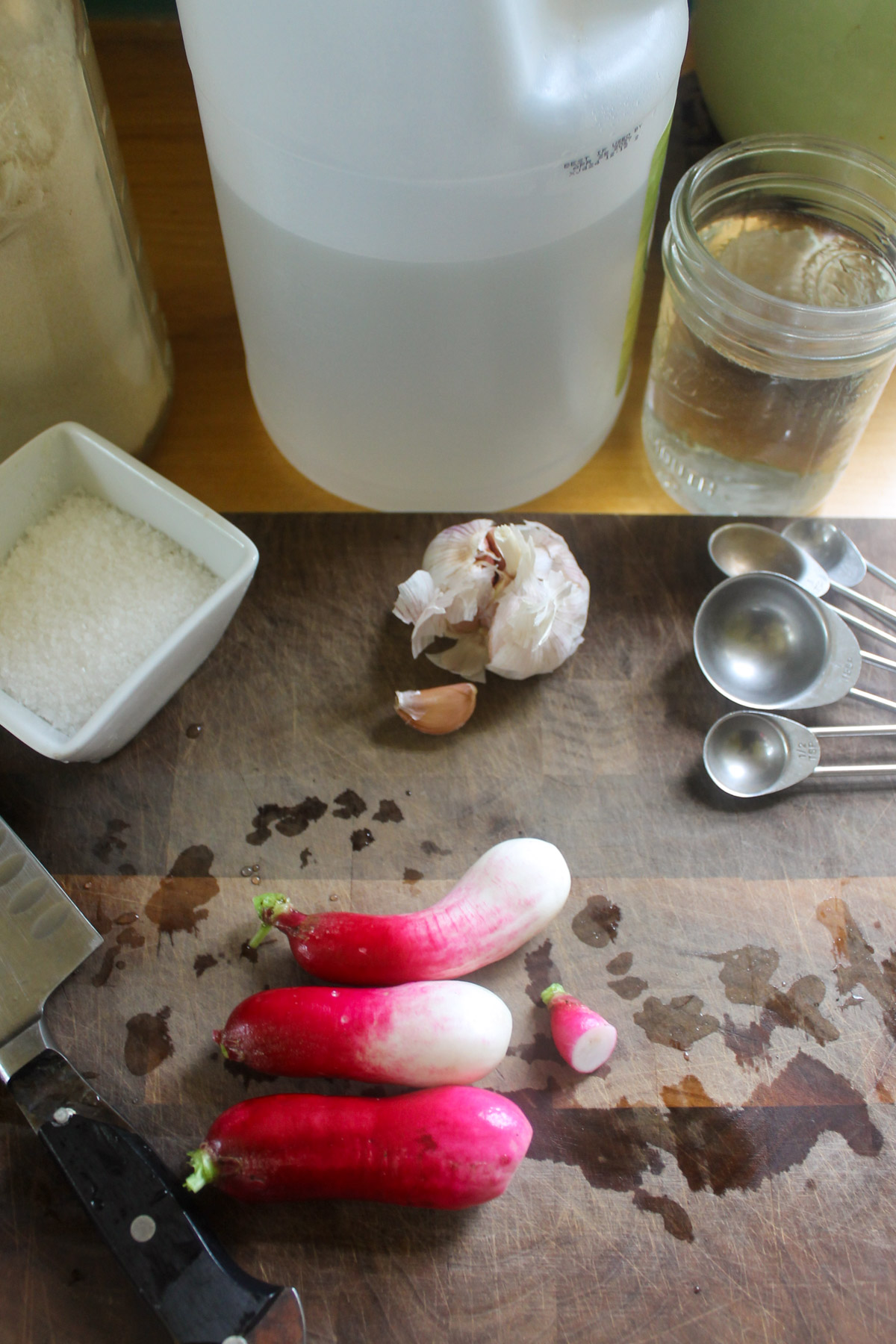 Three washed garden radishes on a cutting board.