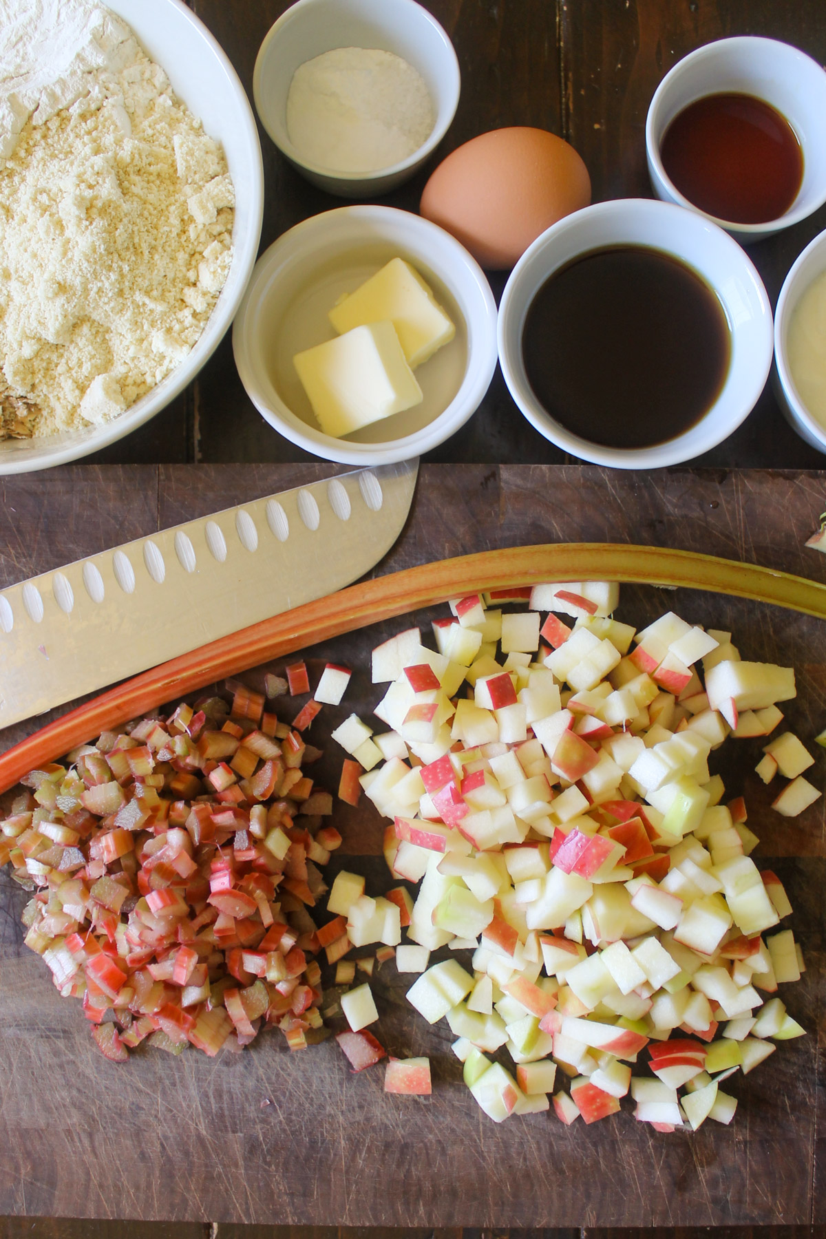 Chopped apples and rhubarb on a cutting board.