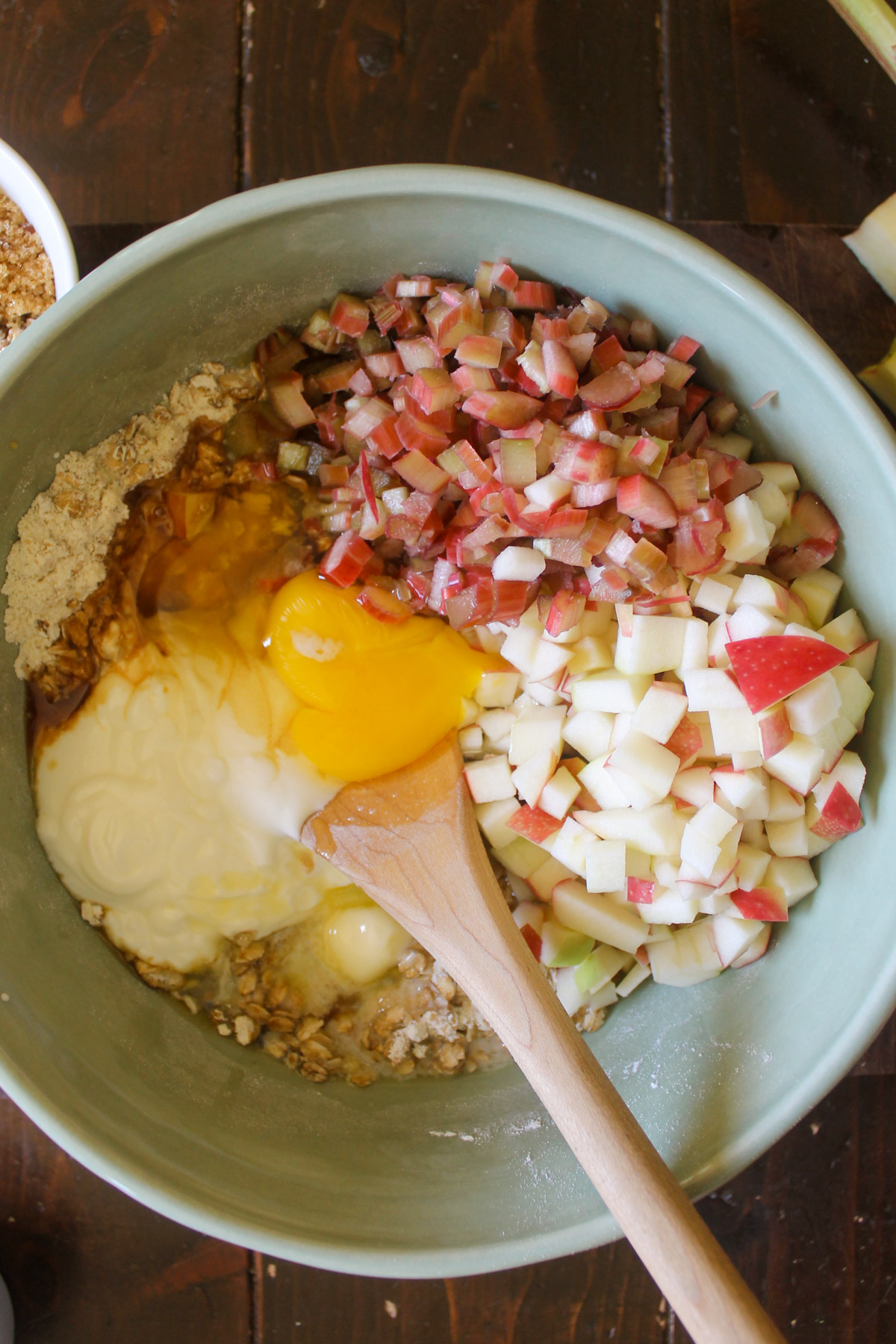 Ingredients for apple rhubarb muffin batter in a bowl.