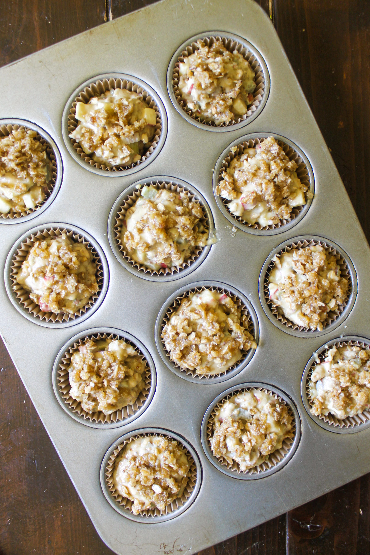 A muffin tin filled with batter ready to bake.