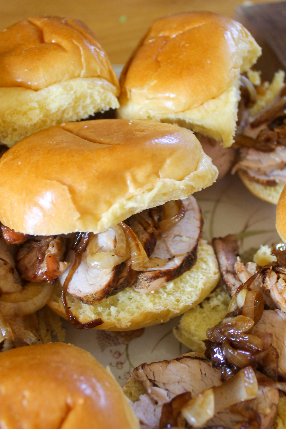 Pork tenderloin sliders on small buns.
