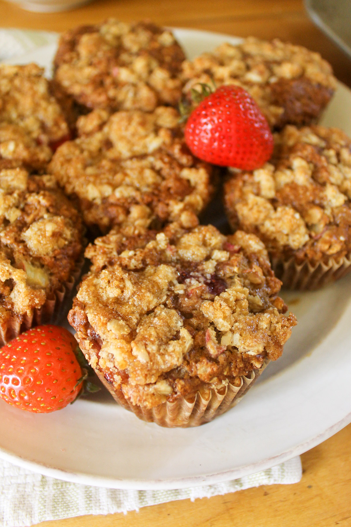 A plate of Strawberry Rhubarb Muffins with oat streusel topping.