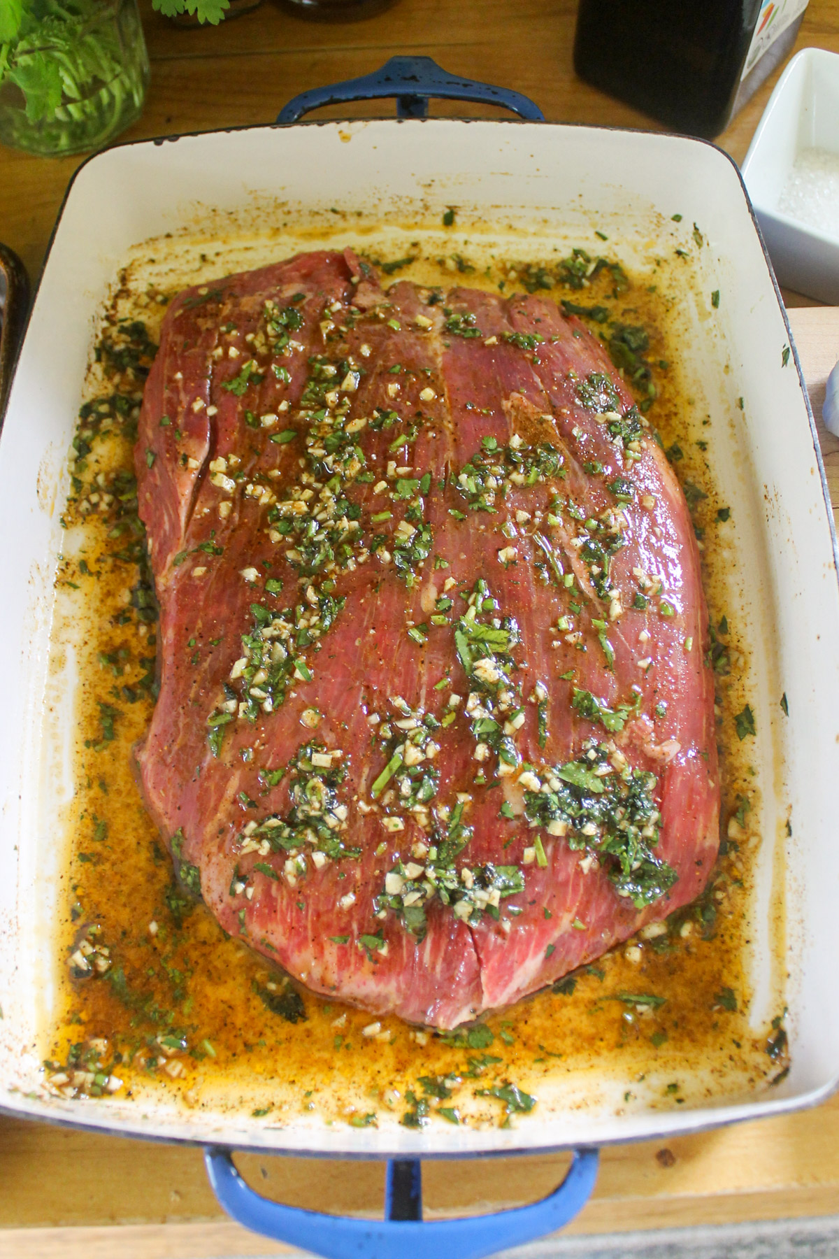 Flank steak in a marinade with garlic and cilantro.