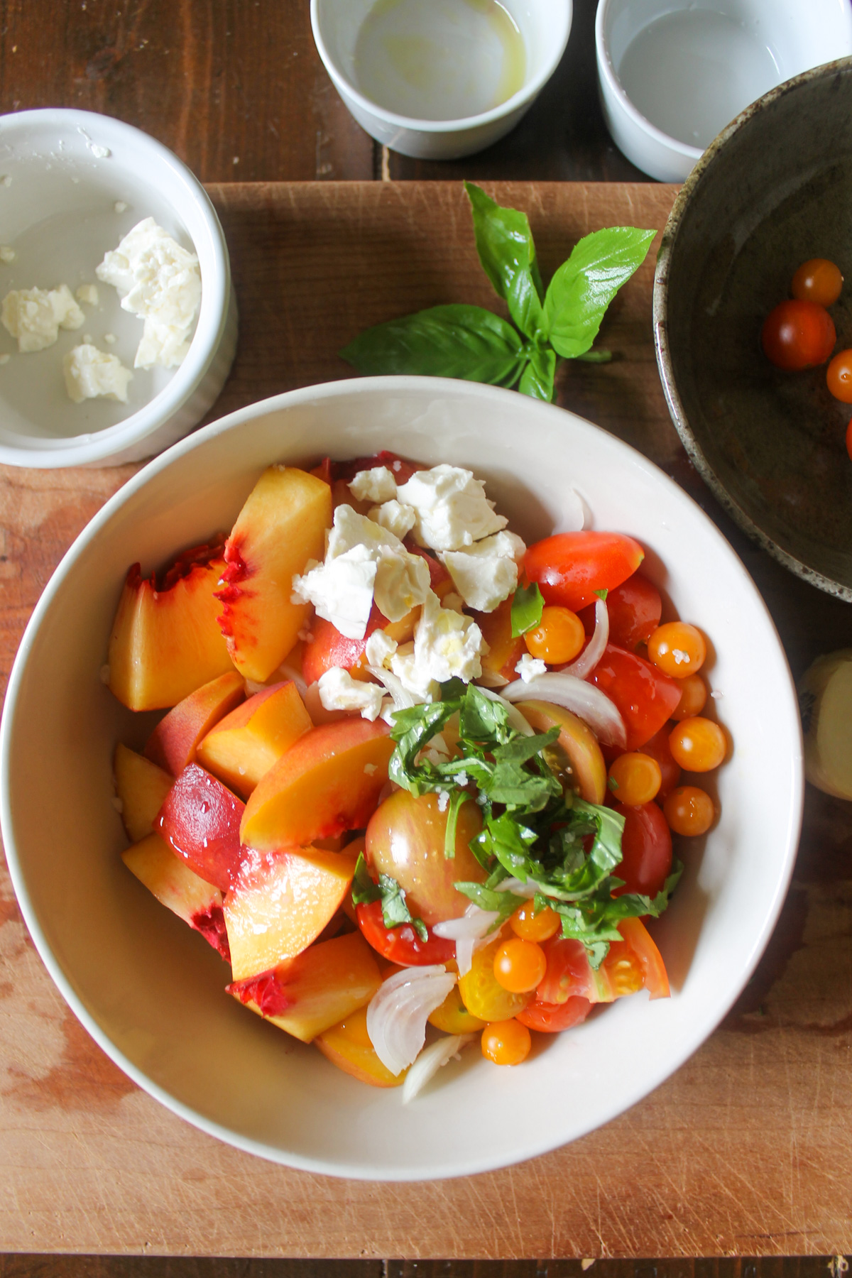 Adding all peach salad ingredients to a bowl.