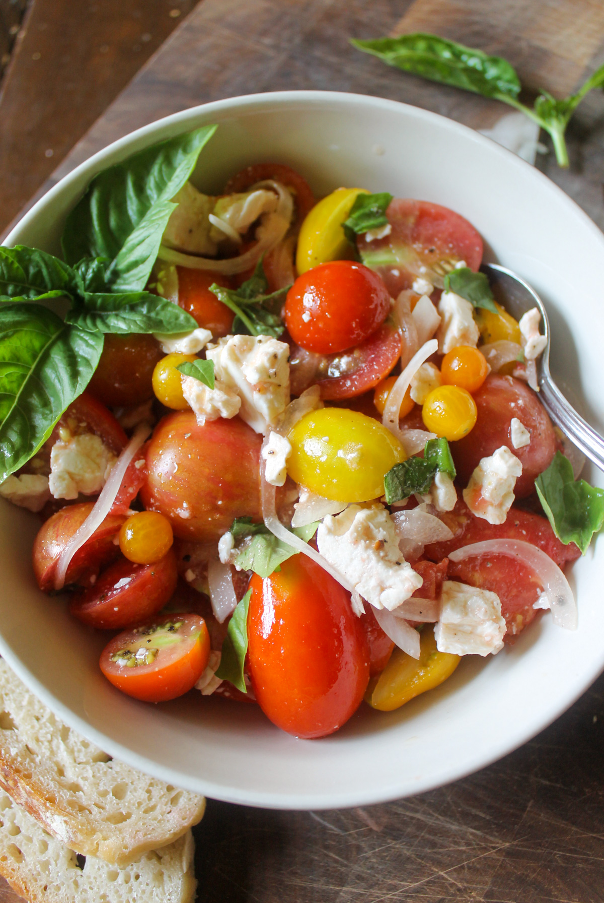 Tomato Onion Salad with feta cheese in a bowl.
