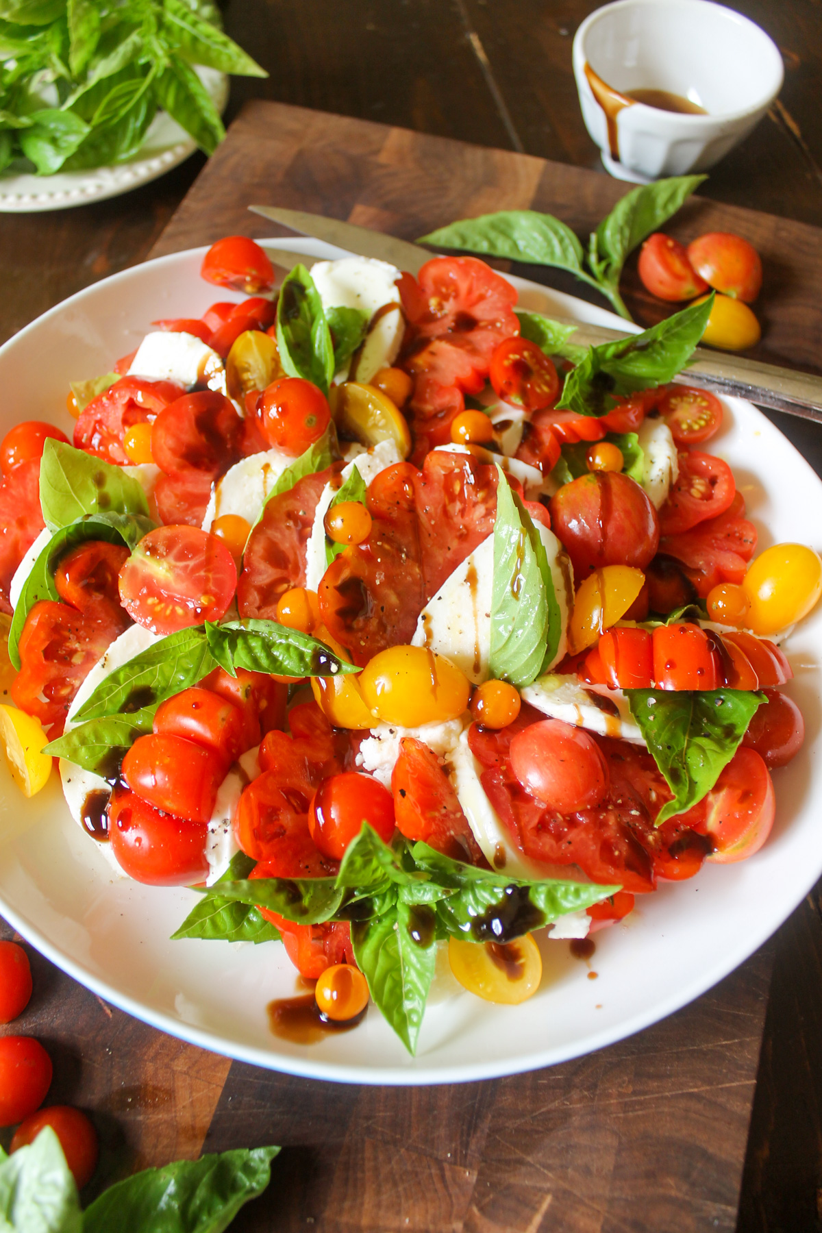 Caprese salad with layered red tomatoes, fresh mozzarella and basil.