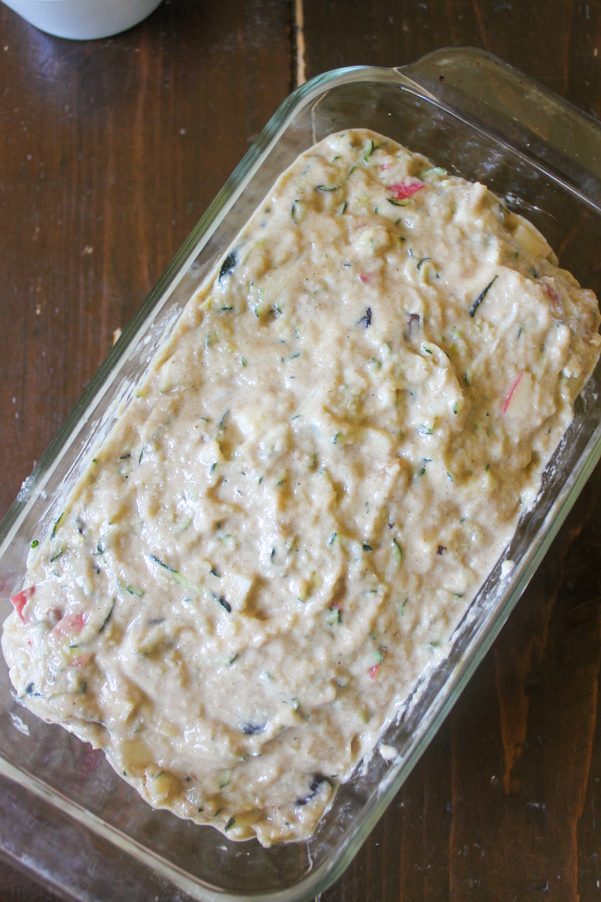 Apple zucchini bread batter in a loaf pan ready to bake.