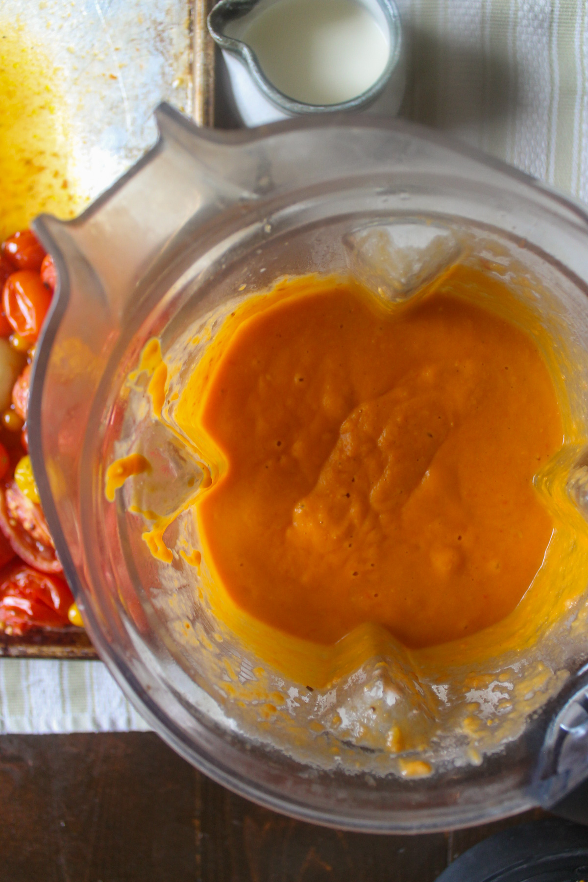 Pureed tomato sweet potato soup in a blender.