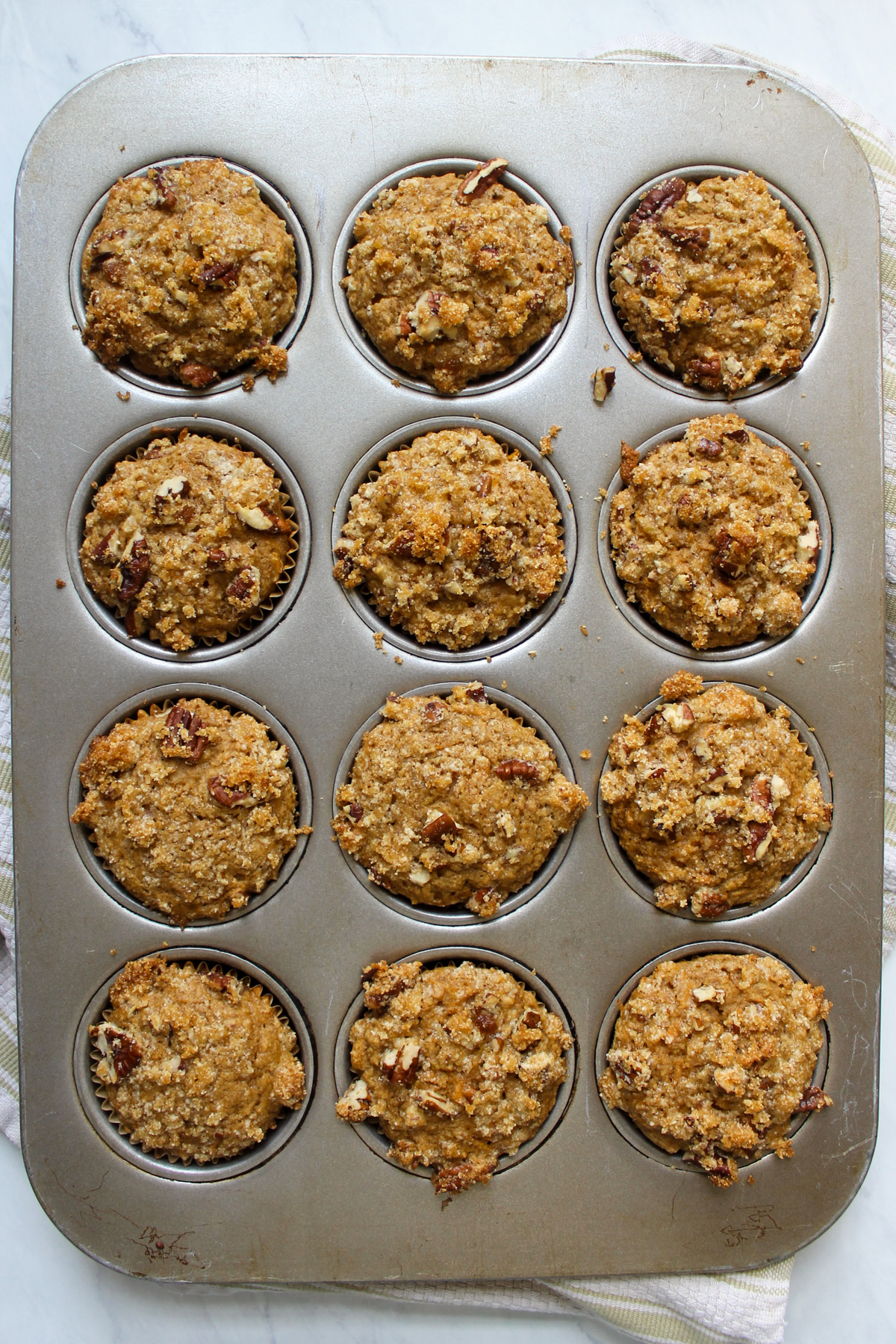 Baked carrot applesauce muffins in muffin tin.